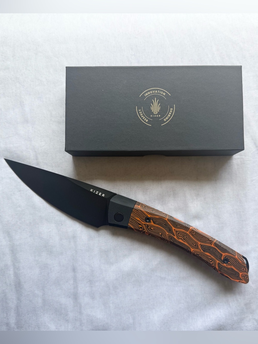 Kizer Folding Knife with Orange & Black Swirl Handle